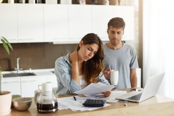 Couple in the kitchen looking at bills