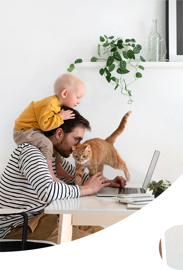 man with his baby and cat trying to get work done