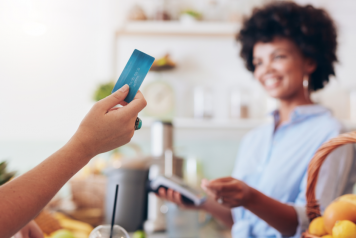 Woman about to make a purchase with a card