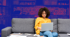 Woman sitting on couch on laptop