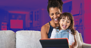 woman and child smiling looking at tablet