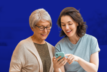 young women and elderly women looking at phone