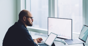 man at work with multiple screens
