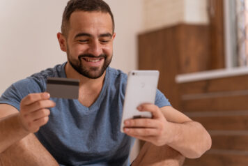 man with credit card and phone